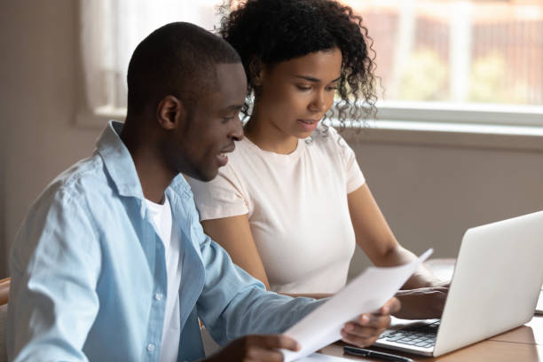 istock Multiethnic couple pay bills on laptop online 1201492813