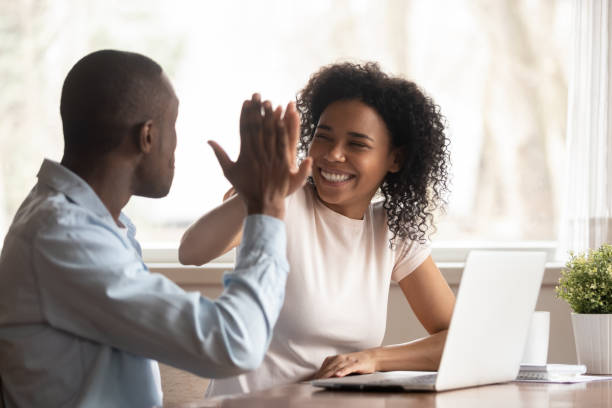 istock Overjoyed biracial couple give high five celebrating success 1201492815