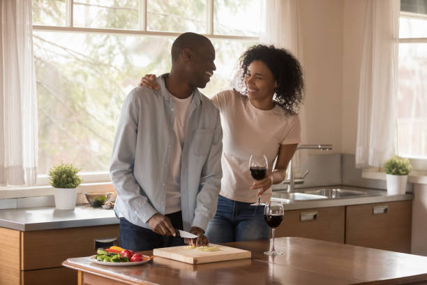 istock Happy biracial couple have fun cooking together in kitchen 1201492829