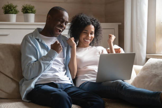 istock Overjoyed biracial couple excited with online win 1201492844