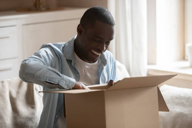 istock Happy biracial man unpack package shopping online 1201492849