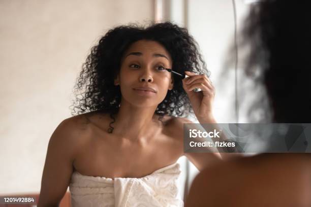 African American Woman Do Makeup In Home Bathroom Stock Photo - Download Image Now - Applying, Mascara, Women