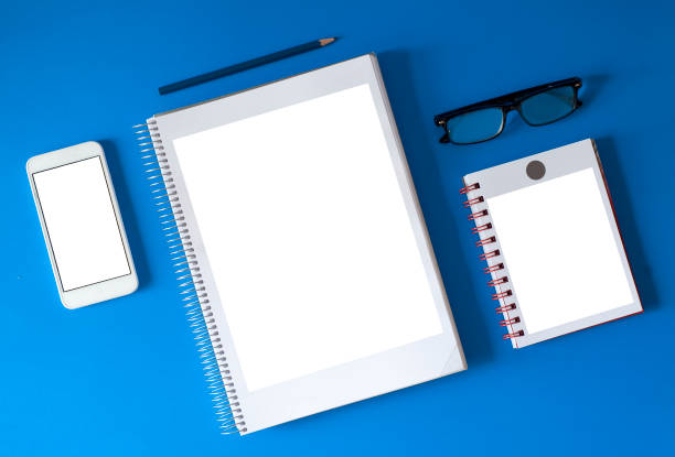 istock composition white paper to fill white phone to fill, blue pencil, glasses black paste retro small notepad fill, classic blue background 1201493005