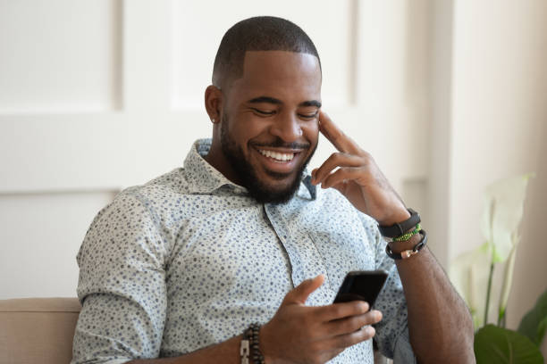 istock Smiling biracial man relax texting on smartphone 1201494891