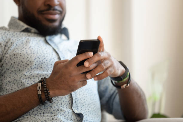 istock Close up of biracial male using cellphone texting 1201494894