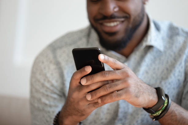istock Close up of smiling biracial man using modern smartphone gadget 1201494900