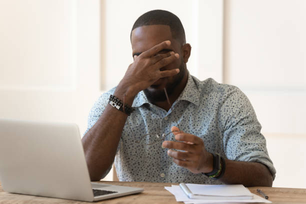 istock Exhausted biracial man take off glasses suffering from headache 1201494923