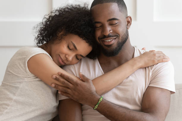 istock Happy African American couple cuddle hugging at home 1201494943