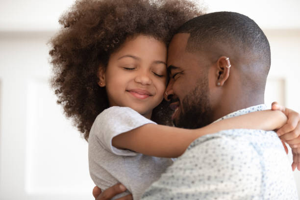 istock Happy biracial dad and daughter cuddle at home 1201494959