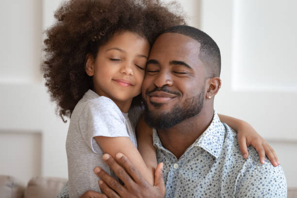 istock Happy african American dad and daughter cuddle touching cheeks 1201494967