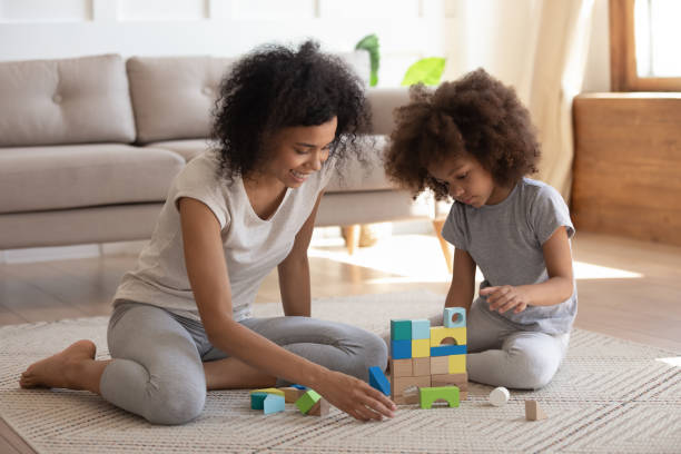 istock Happy biracial mom and daughter play with building bricks 1201494998