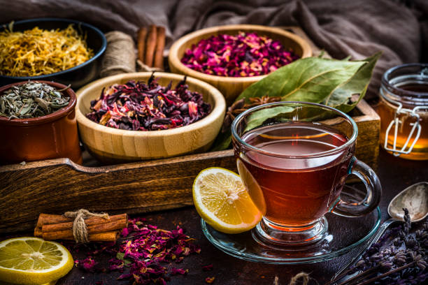 istock Tea cup with several dried tea leaves and flowers 1201496311