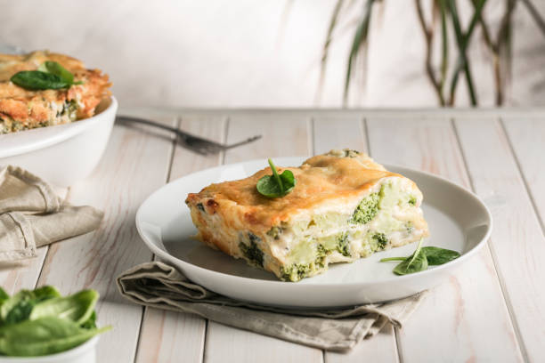 istock Italian lasagna with spinach and broccoli on white plate on bright background with copyspace. Healthy vegetarian food. 1201496534