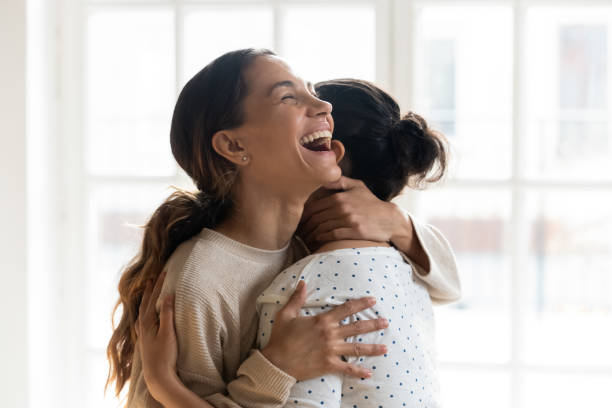 istock Overjoyed girlfriends hug indoors excited to meet 1201499361
