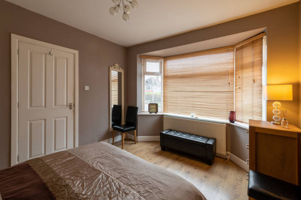 istock Brown bedroom with blinds on the windows 1201503648