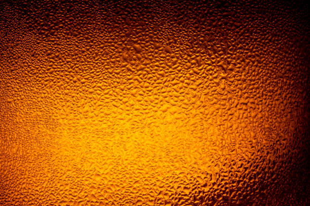 istock water drops on beer background,Drops on the glass,Bottle with a cold drink 1201503721
