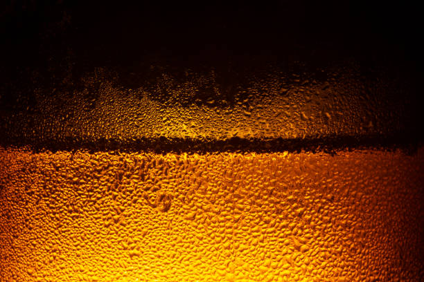 istock water drops on beer background,Drops on the glass,Bottle with a cold drink 1201504250