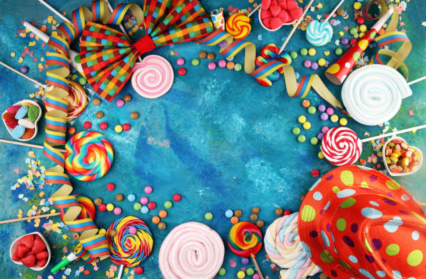 istock Colorful carnival border over a cool textured background with copy space with party hats, candy, streamers and hearts. Party Carnival decoration 1201505327