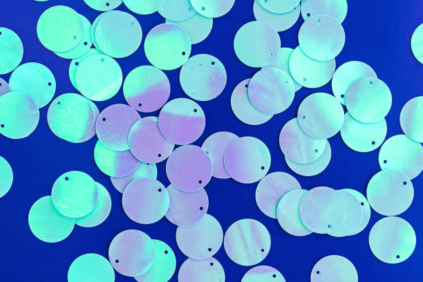 istock Big holographic sequins on classic blue background. 1201505341