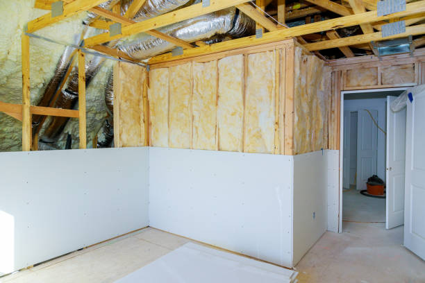 istock Installing plasterboard sheet to wall for attic room construction at the attic termal insulation 1201505400