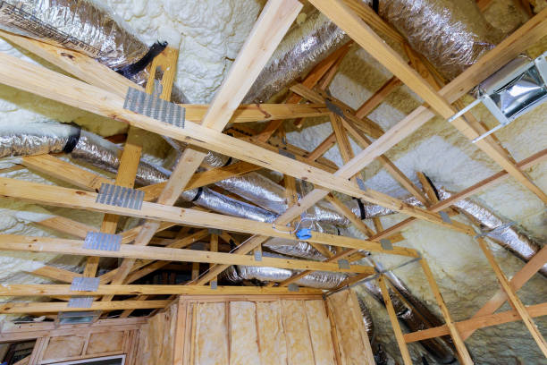istock Installing attic insulation material is sprayed with liquid foam of heating system on the roof 1201505415