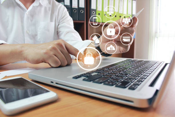 istock young man using laptop computer and hand holding credit card with hologram in office, GDPR. cyber security and privacy concept 1201505430
