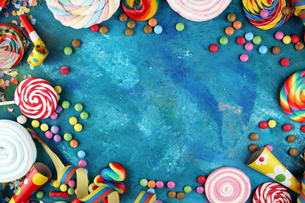istock Colorful carnival border over a cool textured background with copy space with party hats, candy, streamers and hearts. Party Carnival decoration 1201505564