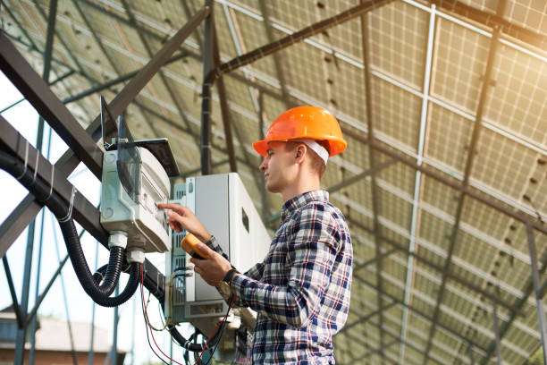 istock Engineer conducts latest work on solar cell launch. Guy in helmet with the sensor in his hands 1201506596