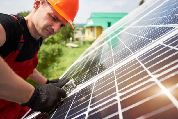 istock Young technician inspecting solar energy on a plot near the house 1201506632