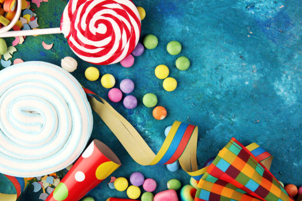 istock Colorful carnival border over a cool textured background with copy space with party hats, candy, streamers and hearts. Party Carnival decoration 1201506654