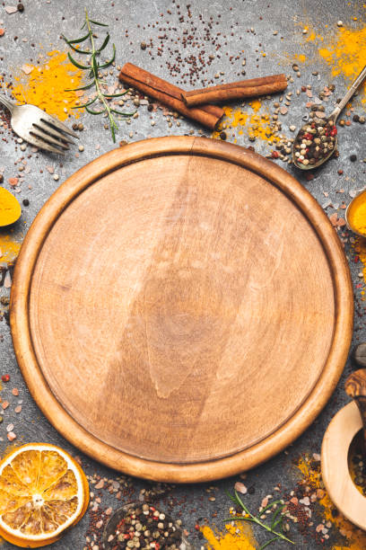 istock Empty wooden cutting board with spices 1201506900