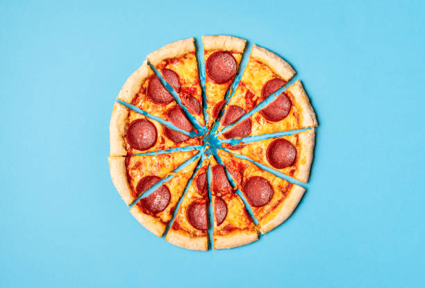 istock Sliced pizza pepperoni on blue background. Pizza salami slices 1201508317
