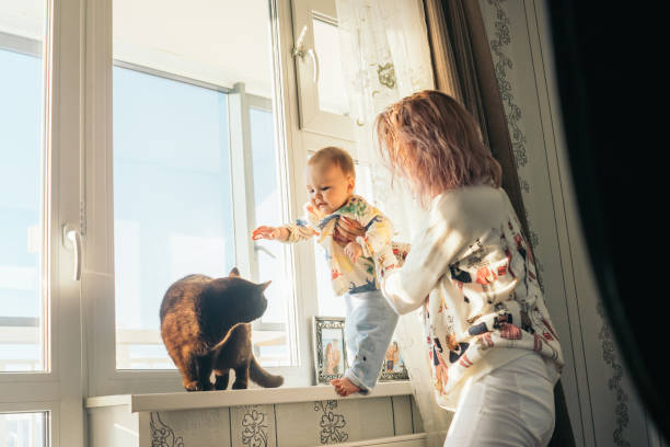 istock Happy young mother with baby and cat. 1201509301
