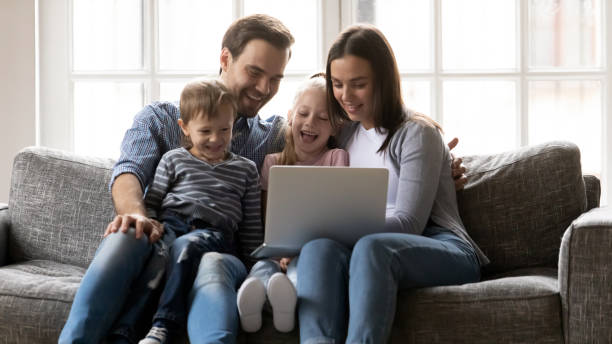istock Happy family with kids have fun using laptop together 1201510255