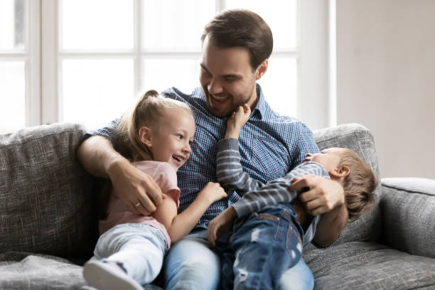istock Overjoyed young dad have fun playing with kids 1201510262