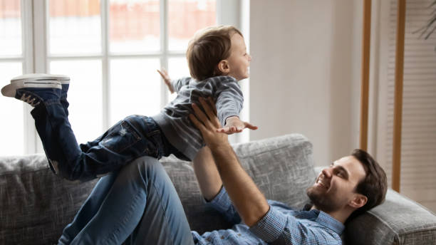 istock Young dad play have fun with small excited son 1201510275