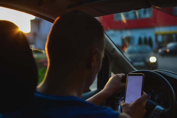 istock Person Sending Text Message By Mobile Phone While Driving Car 1201510507