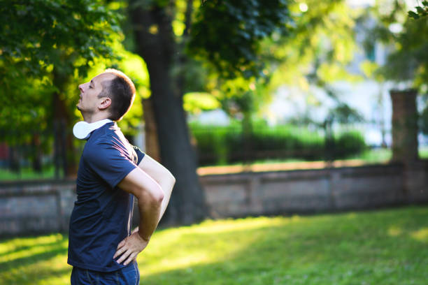 istock Sportsman feeling backache at a park, Backache, Lower Back Pain 1201510832