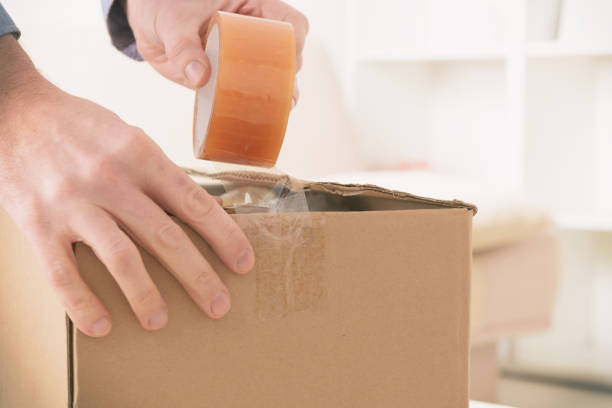 istock Hand taping the cardboard box 1201511433