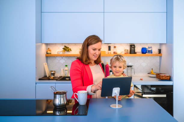 istock Smiling Mother and Young Son Using Digital Tablet Together 1201511865