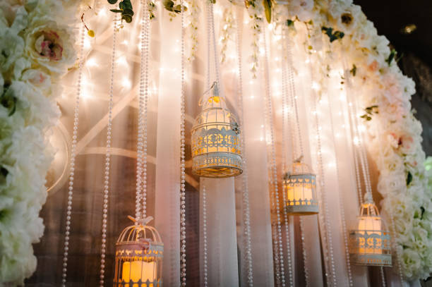 istock Arch for wedding area a is decorated with white flowers and greenery. Wedding ceremony with a vintage candles. 1201512929