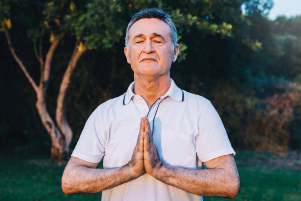 istock Senior man meditating at the park 1201516530