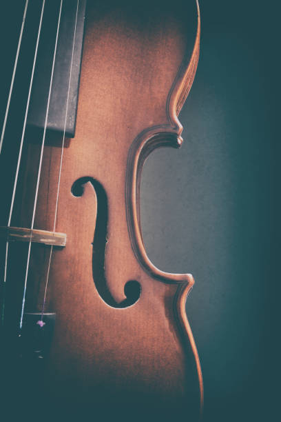 istock Violin detail with dark background vertical vintage 1201518612