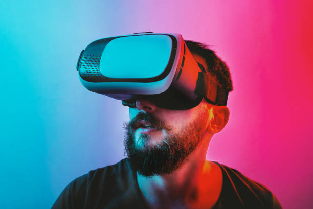 istock Man with Virtual Reality Glasses on a blue and red colored background. 1201518631