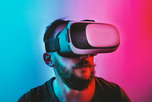 istock Man with Virtual Reality Glasses on a blue and red colored background. 1201518636