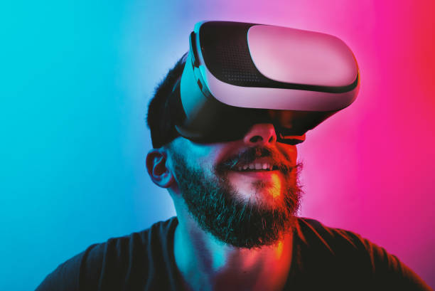 istock Man with Virtual Reality Glasses on a blue and red colored background. 1201518647