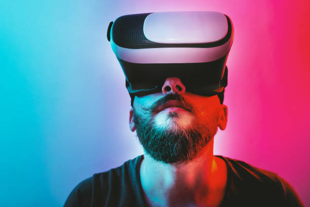 istock Man with Virtual Reality Glasses on a blue and red colored background. 1201518649