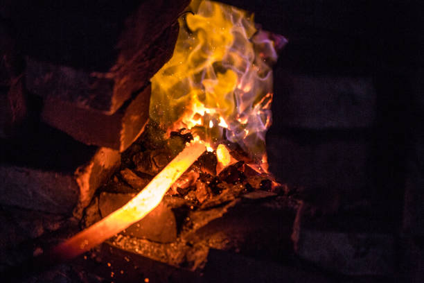 istock In a blacksmith's workshop. The metal billet is held in a coal flame in a furnace. An example of the hard work of ancient crafts. 1201519542