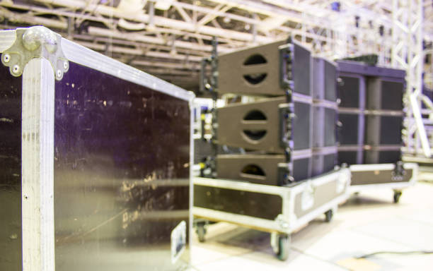 istock Blurred background of flight case with line array speakers. Installation of professional concert sound equipment with bokeh effect. 1201519764