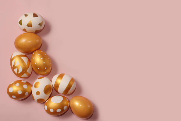 istock Decorated golden easter eggs on a pink background. Minimal holiday concept. Happy easter background. Creative painting of eggs at home. 1201519873
